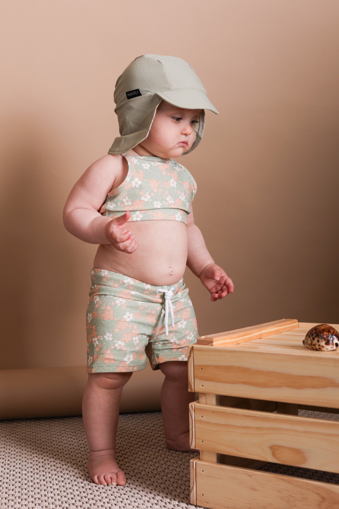 Girl playing in Evangelina sage swim top by KidORCA