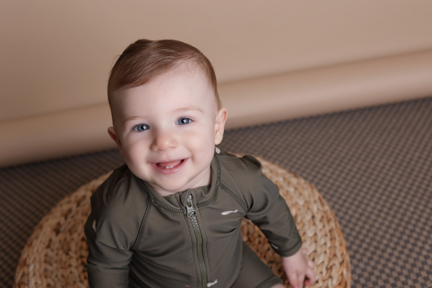 Baby playing in Trout Kalamata swim jumpsuit by KidORCA