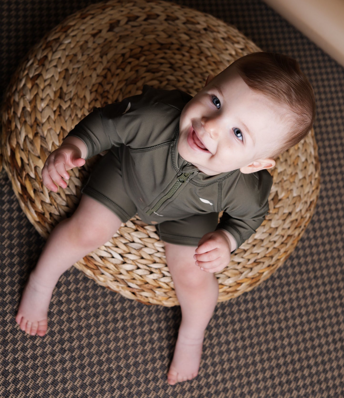 Baby playing in Trout Kalamata swim jumpsuit by KidORCA