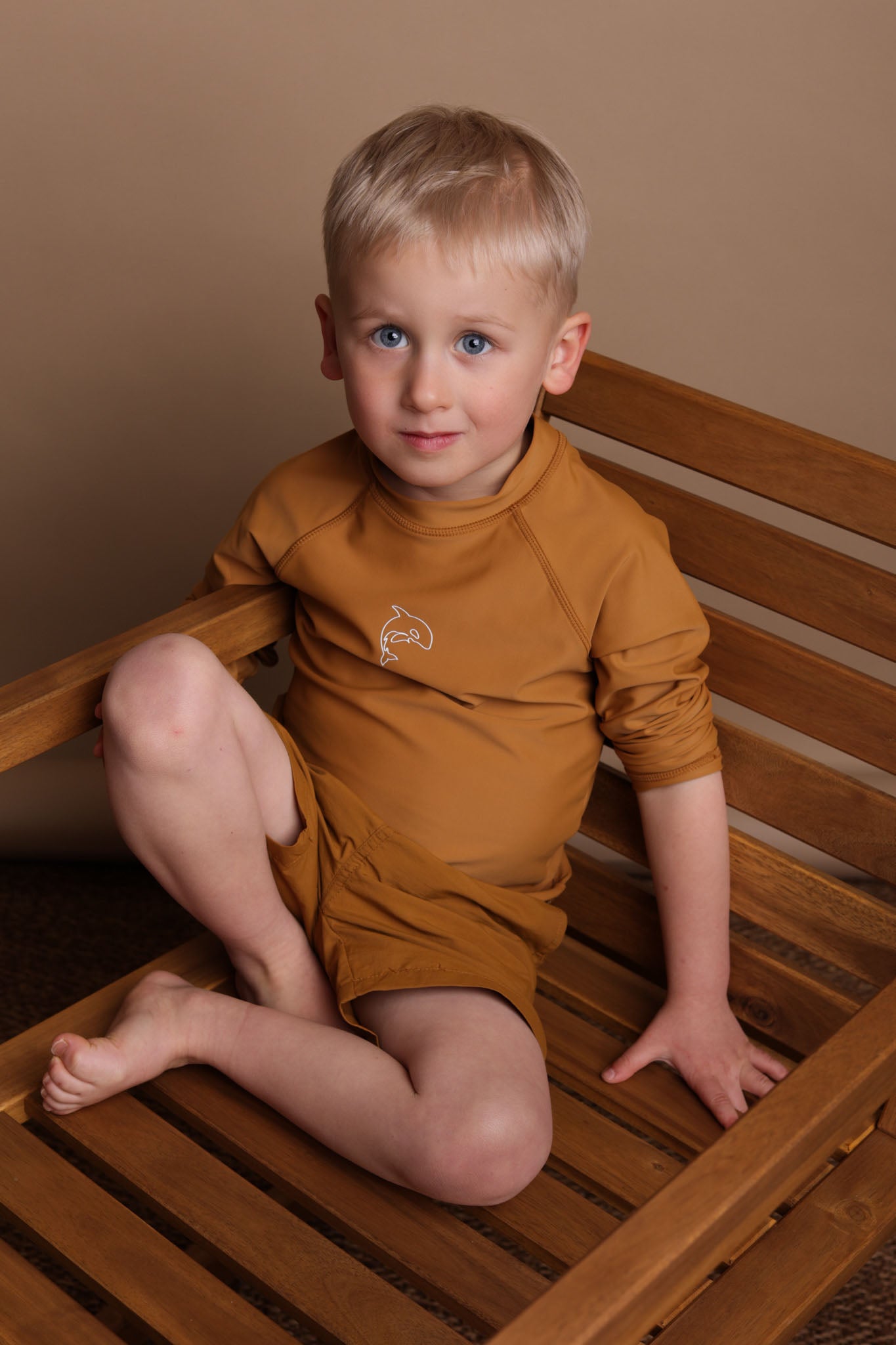 Boy wearing ginger long sleeve rashguard – side view