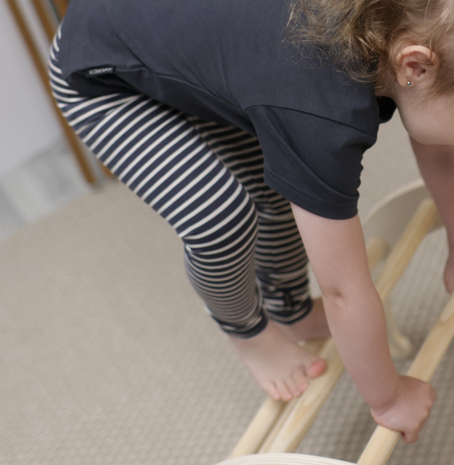 Kid playing in lava striped organic leggings by KidORCA
