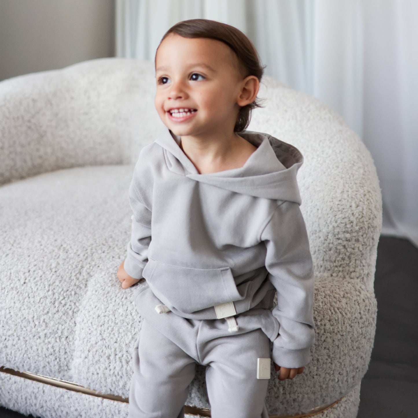 Child wearing dove grey brushed terry sweatpants – side view with elastic waist