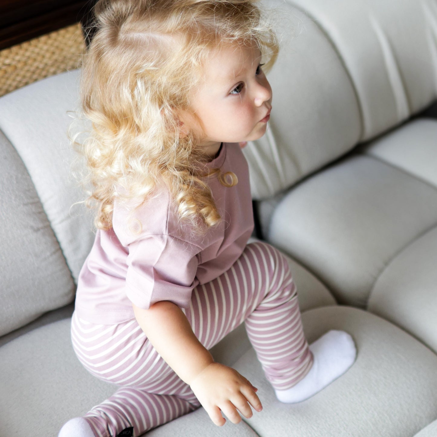 Kid playing in mauve organic cotton tee by KidORCA