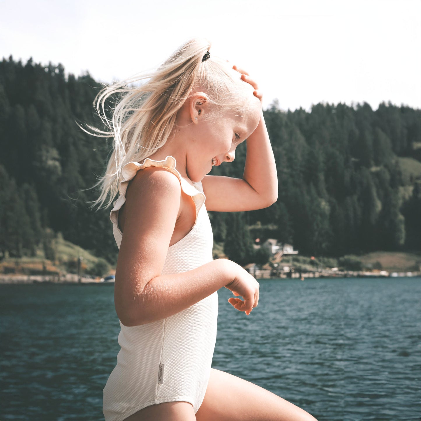 Girl wearing almond waffle weave swimsuit – side view