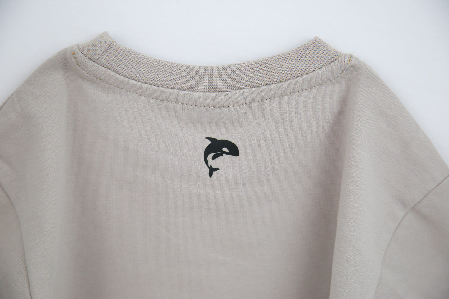 Close-up of organic cotton fabric and crew neckline – dove kids tee