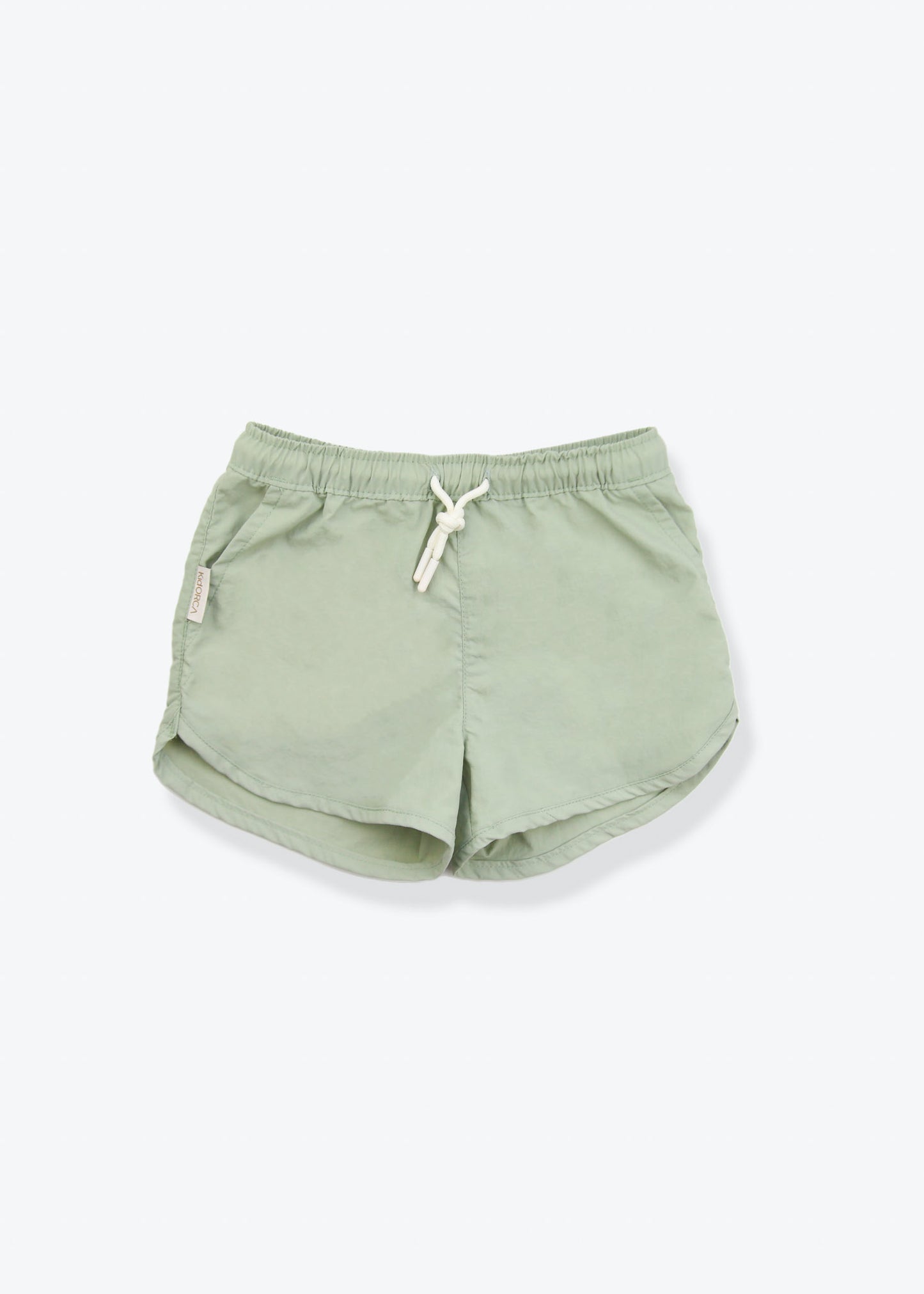 Girls swim trunks in sage green – front view