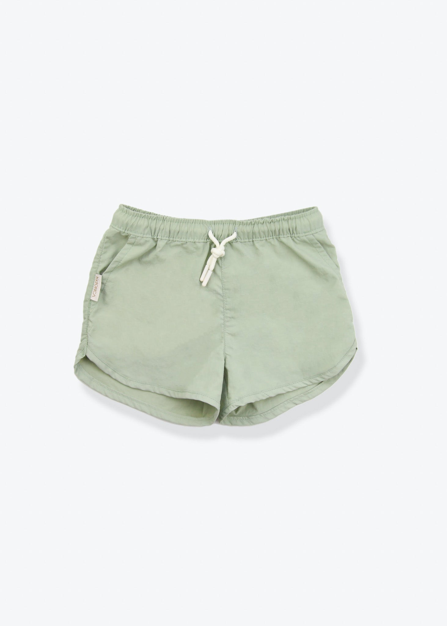 Girls swim trunks in sage green – front view