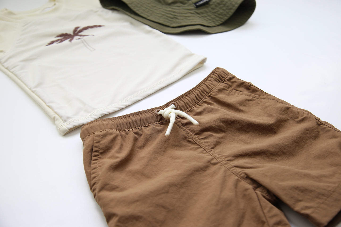 Elastic waistband detail on mocha boys swim trunks