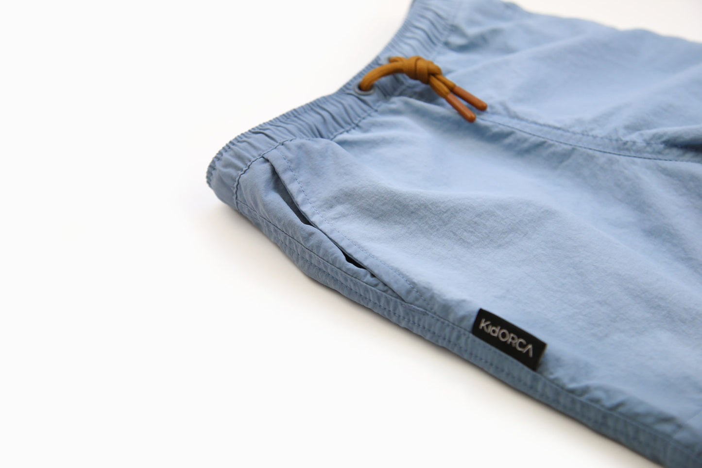 Elastic waistband detail on sky blue boys swim trunks