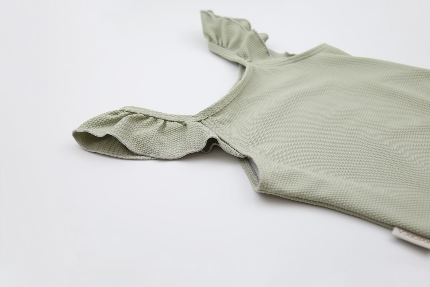 Close-up of waffle weave textured quick-dry fabric – sage swimsuit