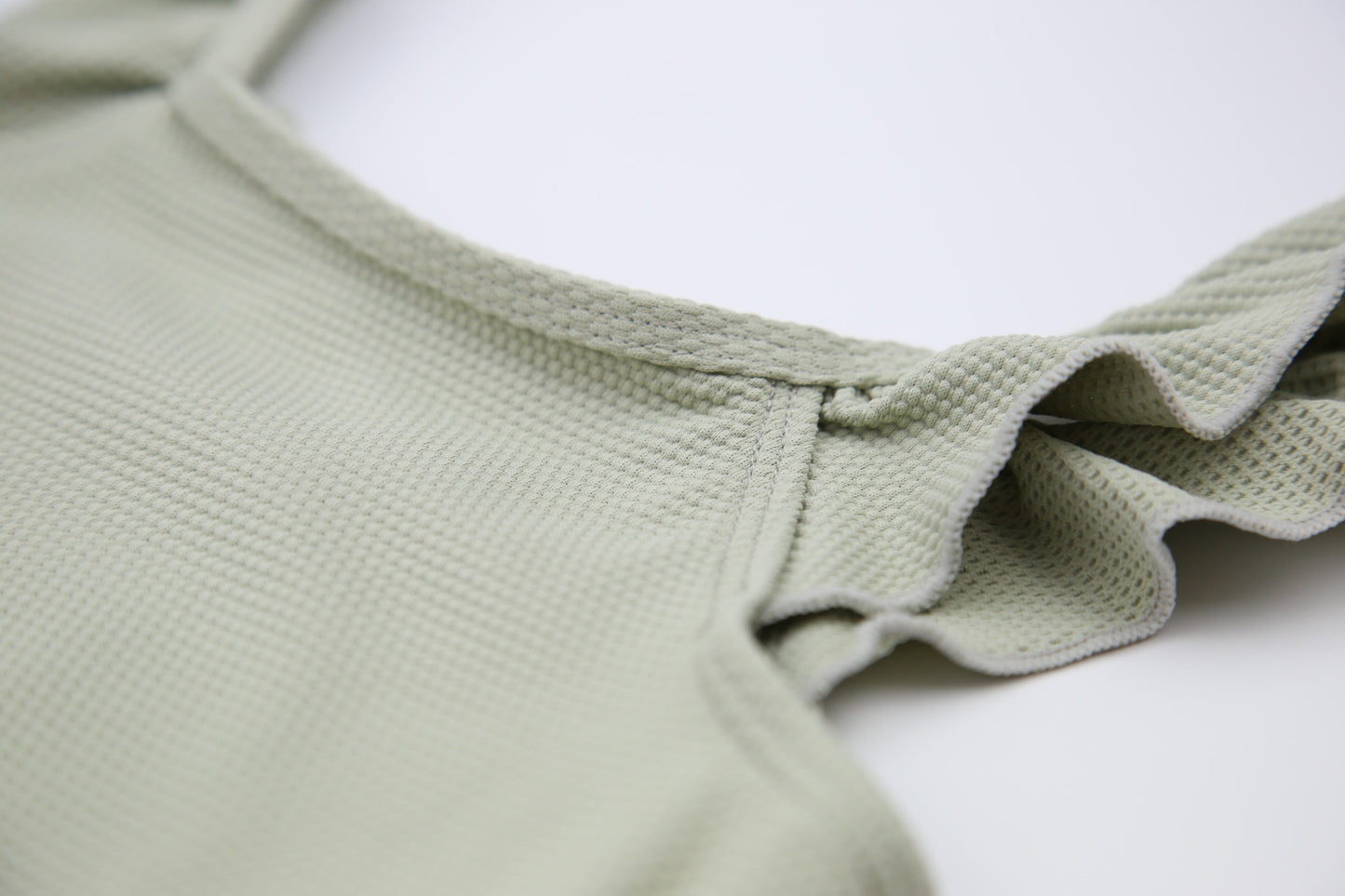 Close-up of waffle weave textured quick-dry fabric – sage swimsuit