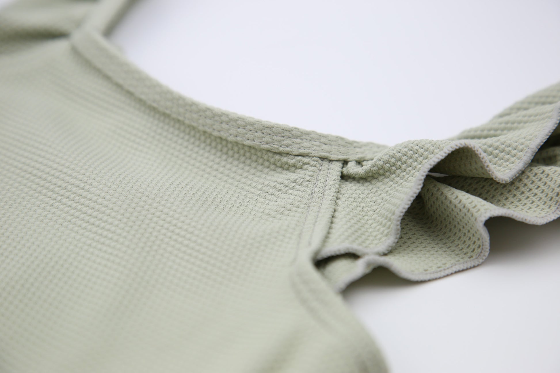 Close-up of waffle weave textured quick-dry fabric – sage swimsuit