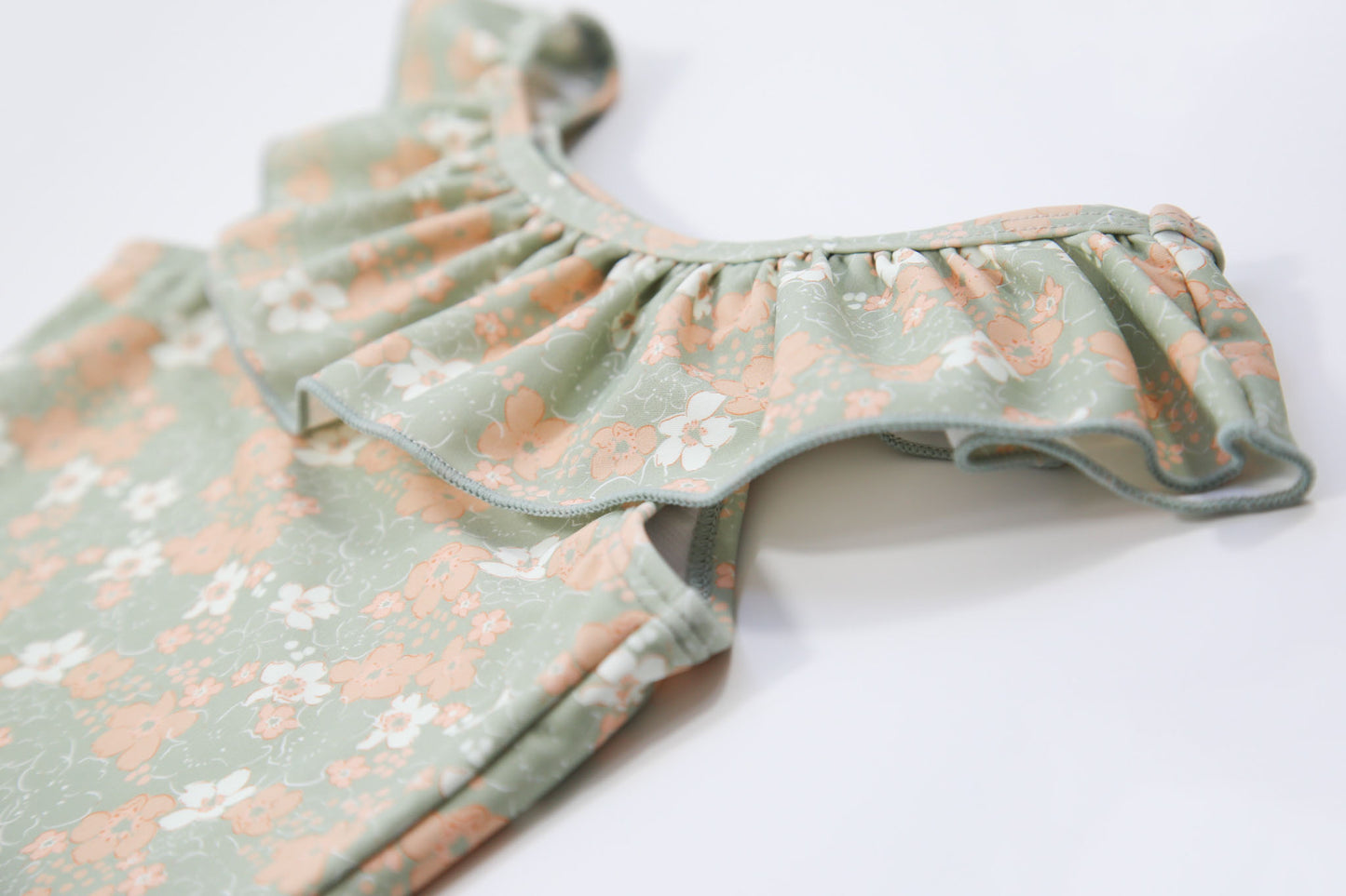 Close-up of textured quick-dry fabric – sage ruffle swimsuit
