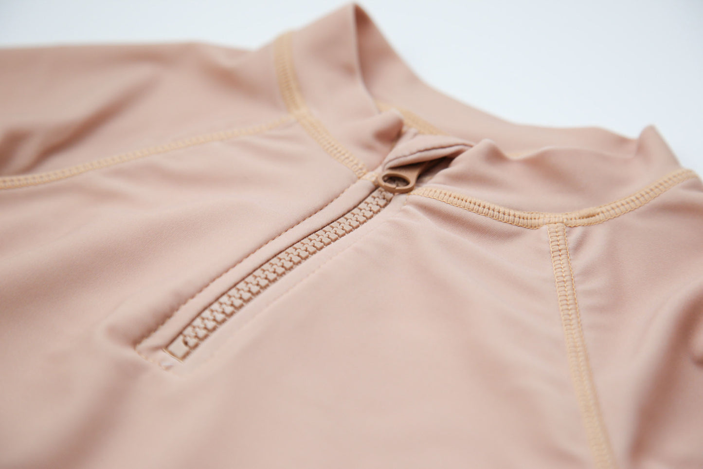 Girl wearing Tuscany rashguard – side view with long sleeves and zipper