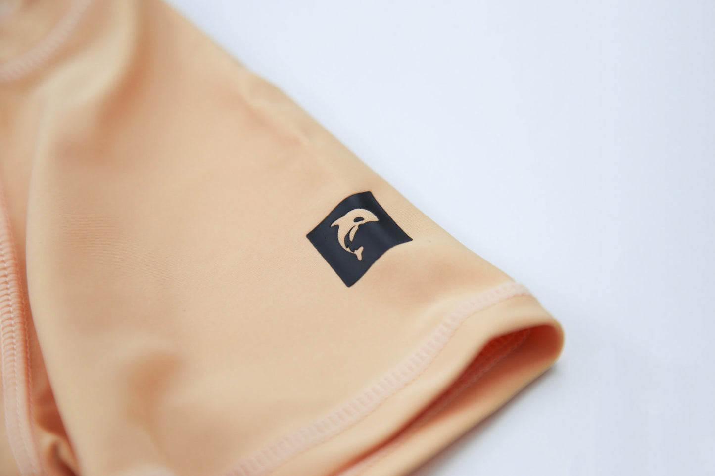 Close-up of UPF 50+ quick-dry recycled polyester – desert sand rashguard
