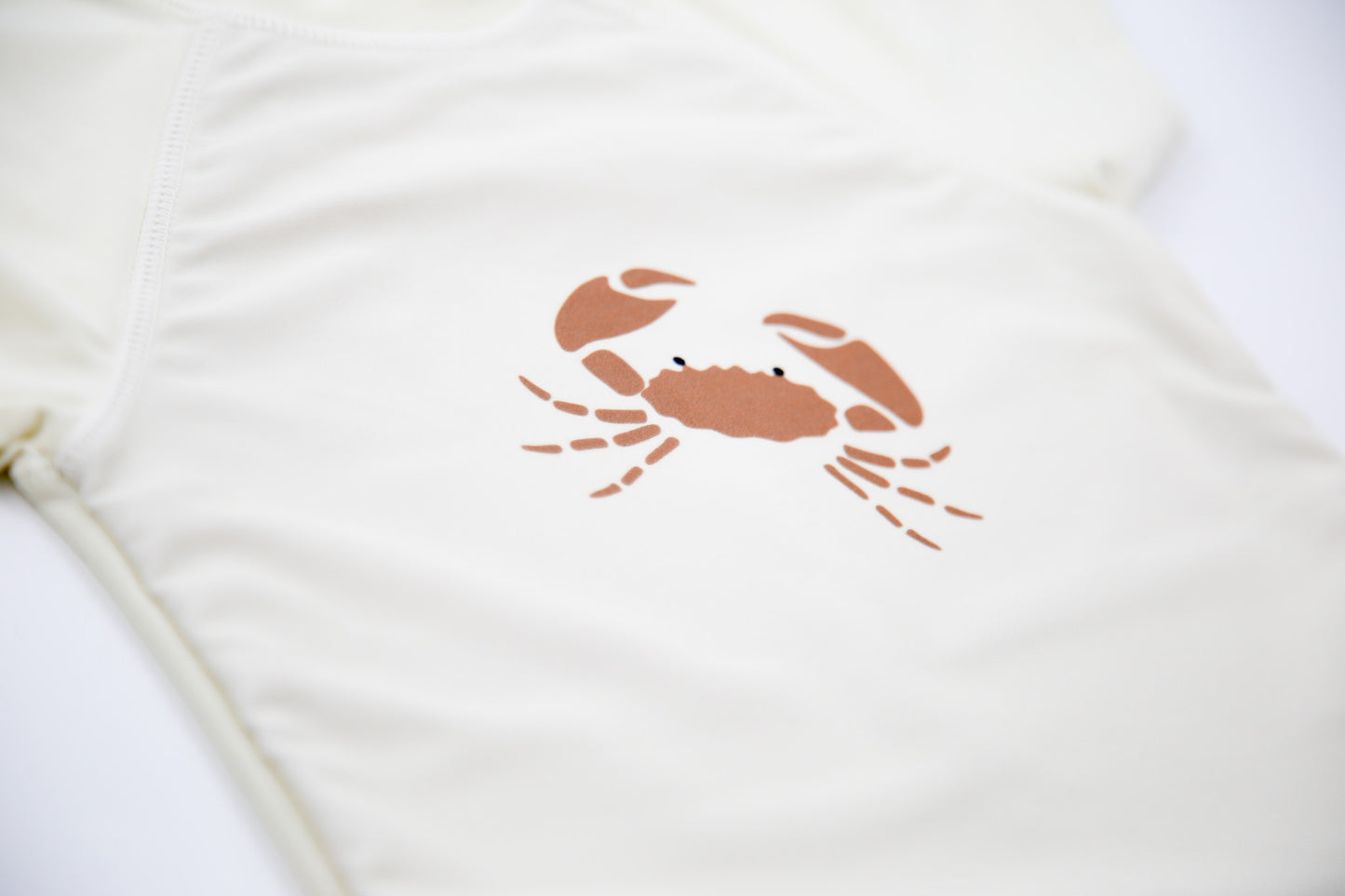 Close-up of UPF 50+ quick-dry recycled polyester – crab rashguard