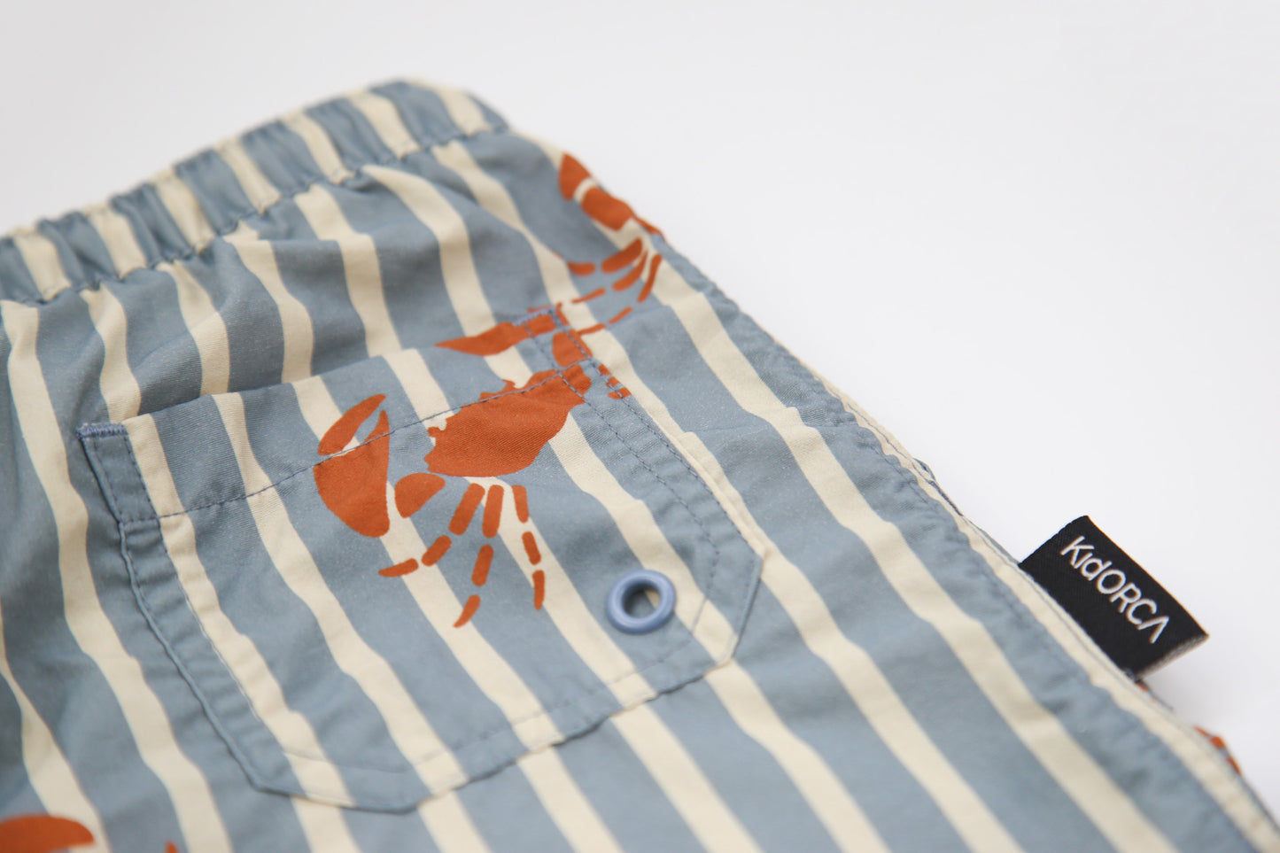 Close-up of quick-dry recycled polyester fabric – crab slate swim trunks