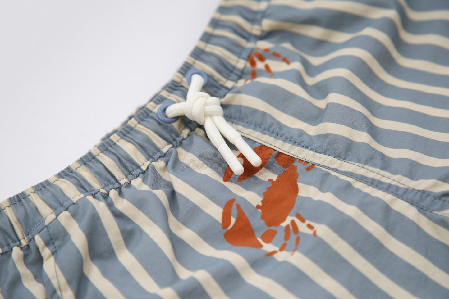 Elastic waistband detail on crab slate boys swim trunks