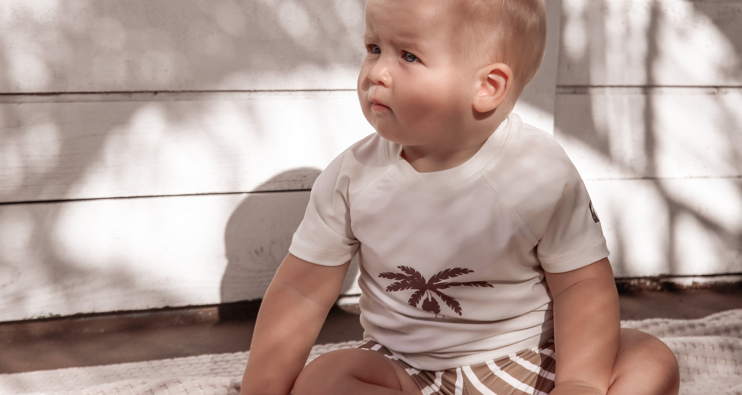 Kid playing in stripe khaki swim boardie shorts by KidORCA