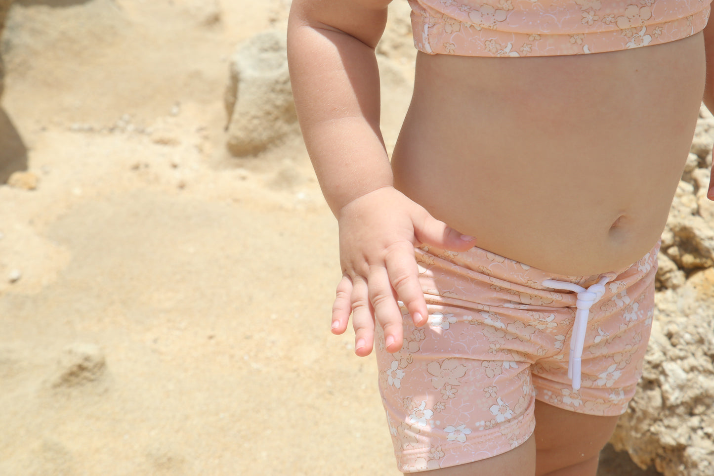 Girl playing in Tuscany print swim boardie shorts by KidORCA
