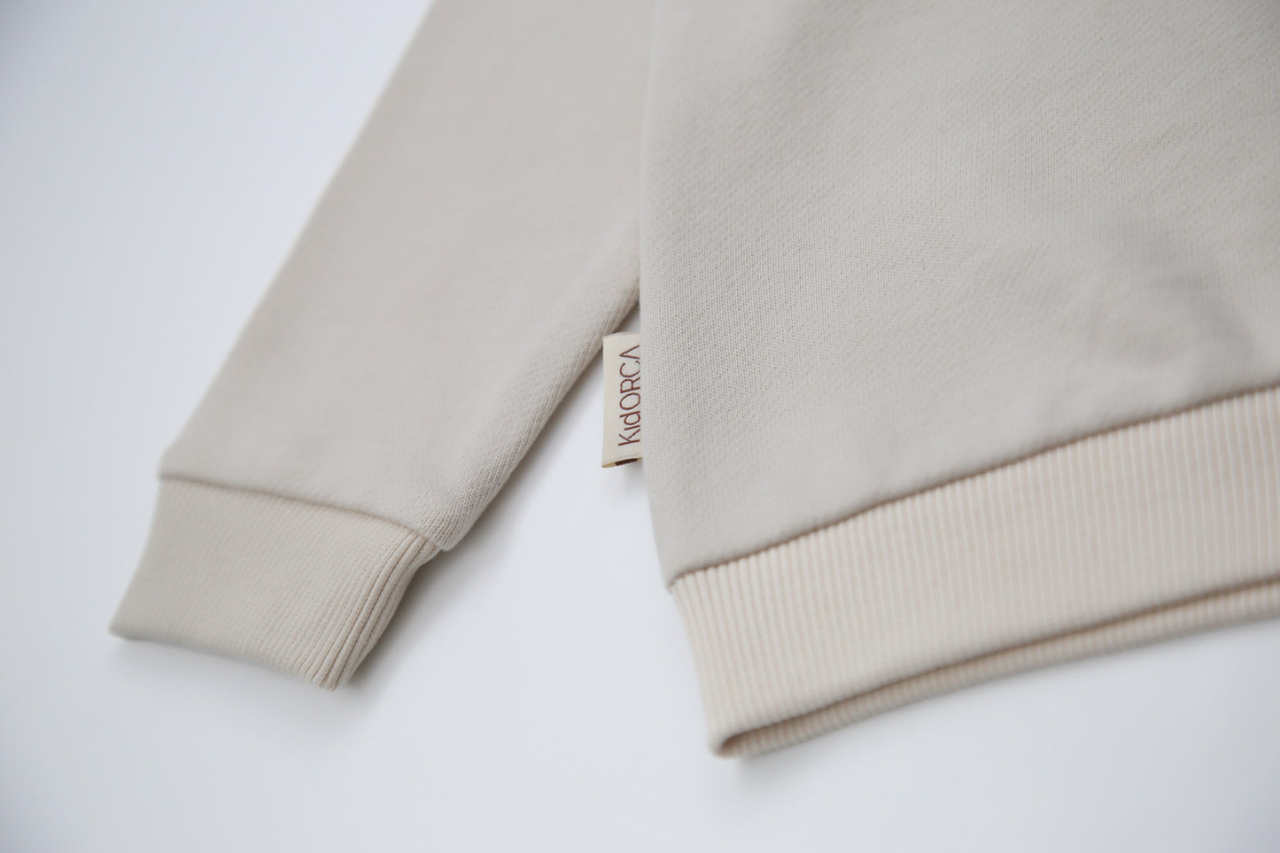 Rib cuff and hem detail on oat french terry kids sweatshirt