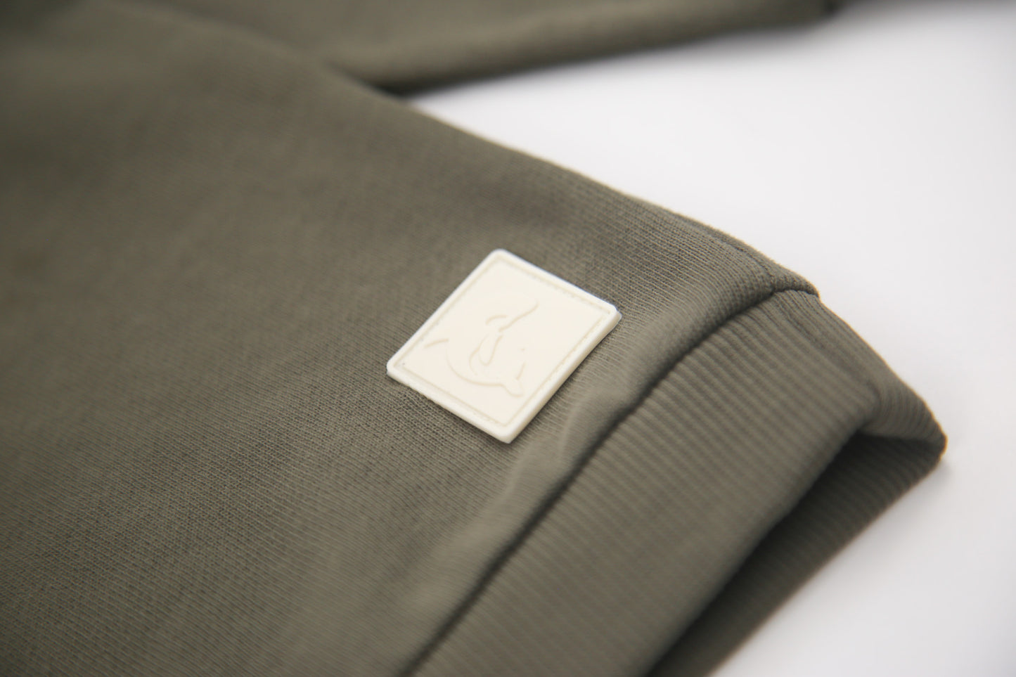 Rib cuff and hem detail on dusty olive french terry kids sweatshirt