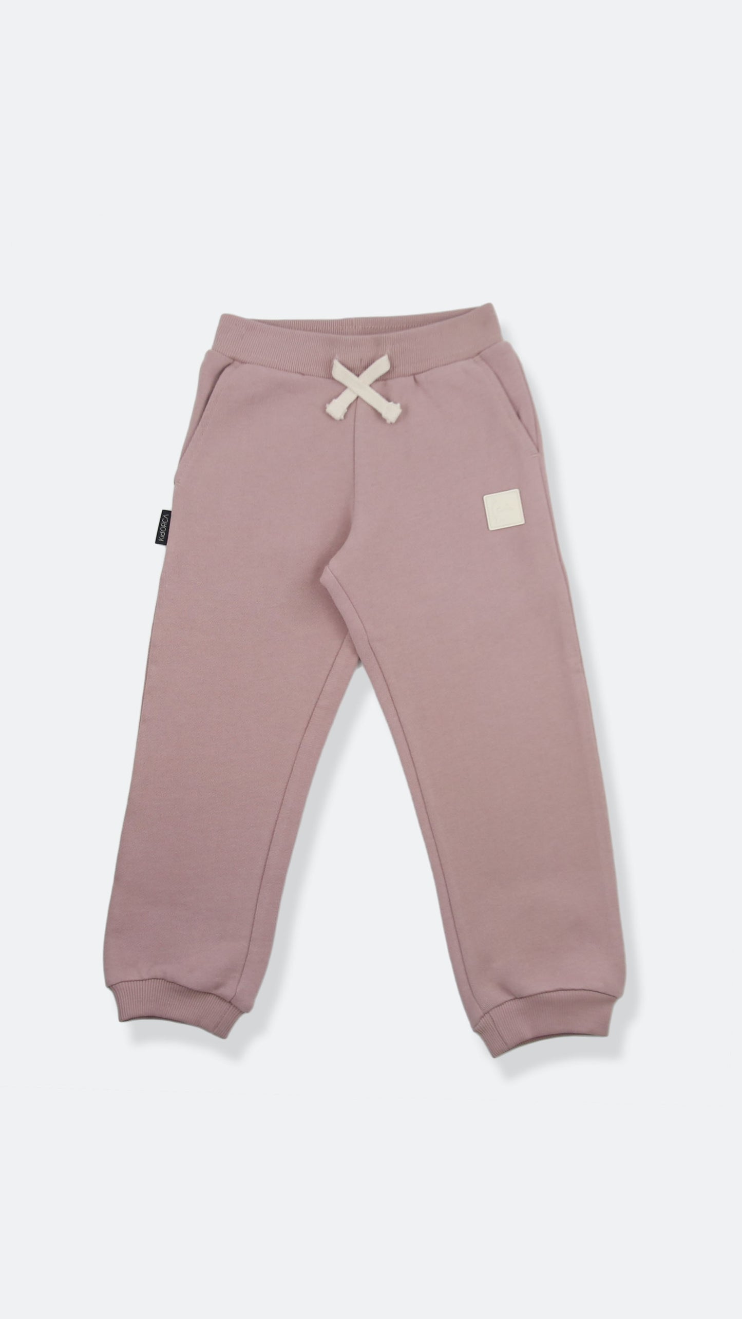 Organic french terry kids sweatpants in mauve color – front view