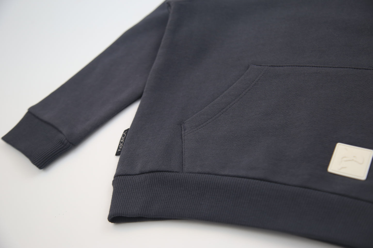 Kangaroo pocket and rib cuff detail on lava brushed terry kids hoodie