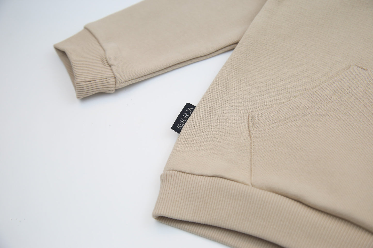 Kangaroo pocket and rib cuff detail on wheat brushed terry kids hoodie