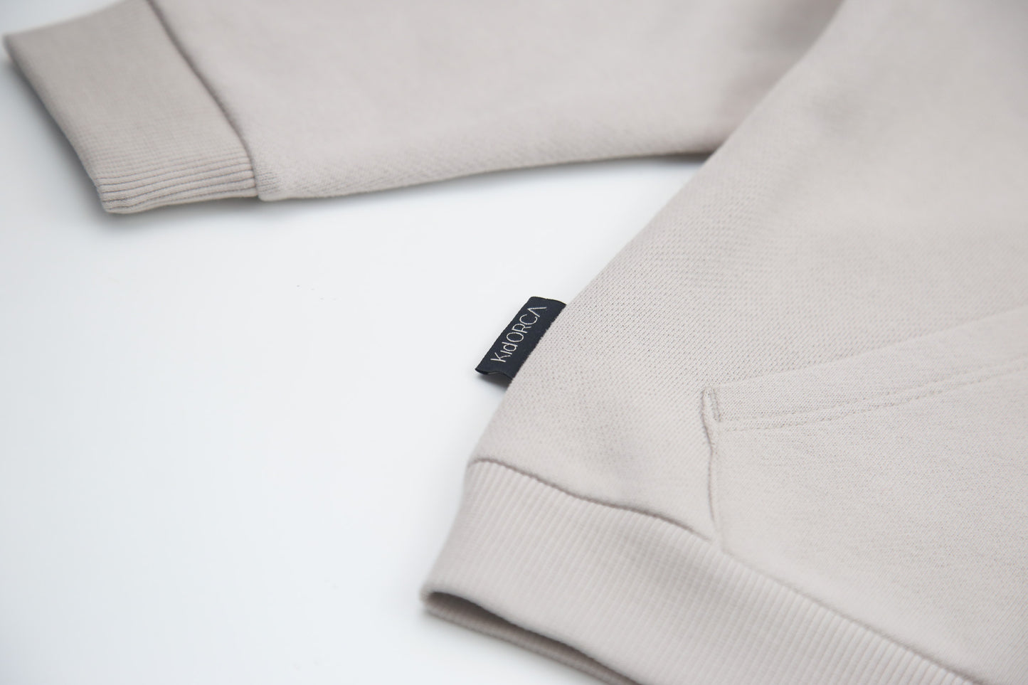 Kangaroo pocket and rib cuff detail on dove brushed terry kids hoodie
