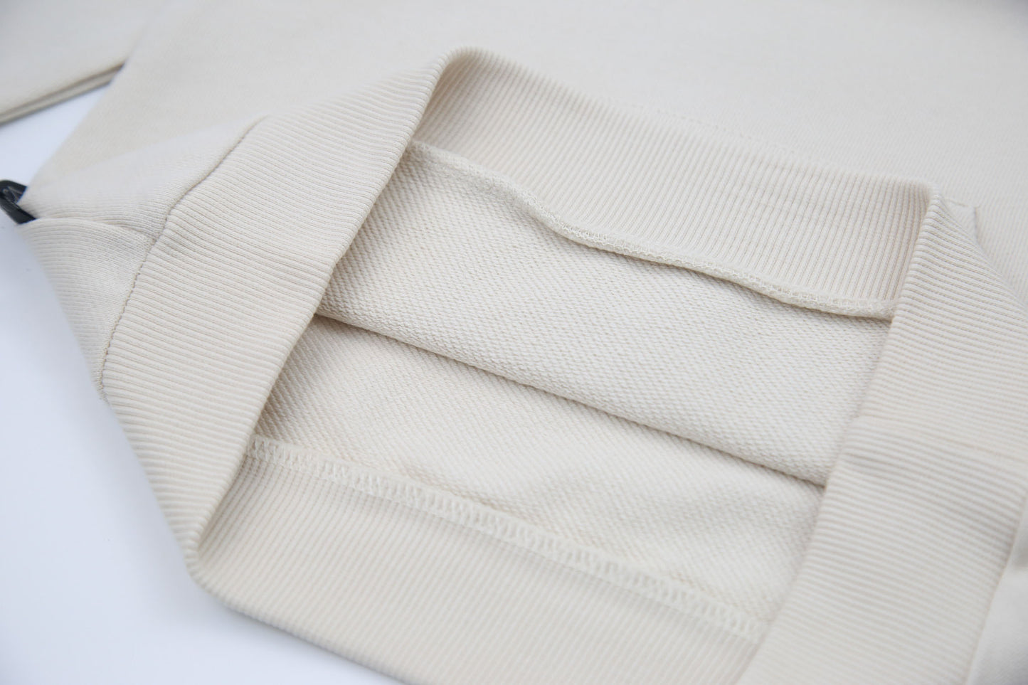 Kangaroo pocket and rib cuff detail on oat french terry kids hoodie
