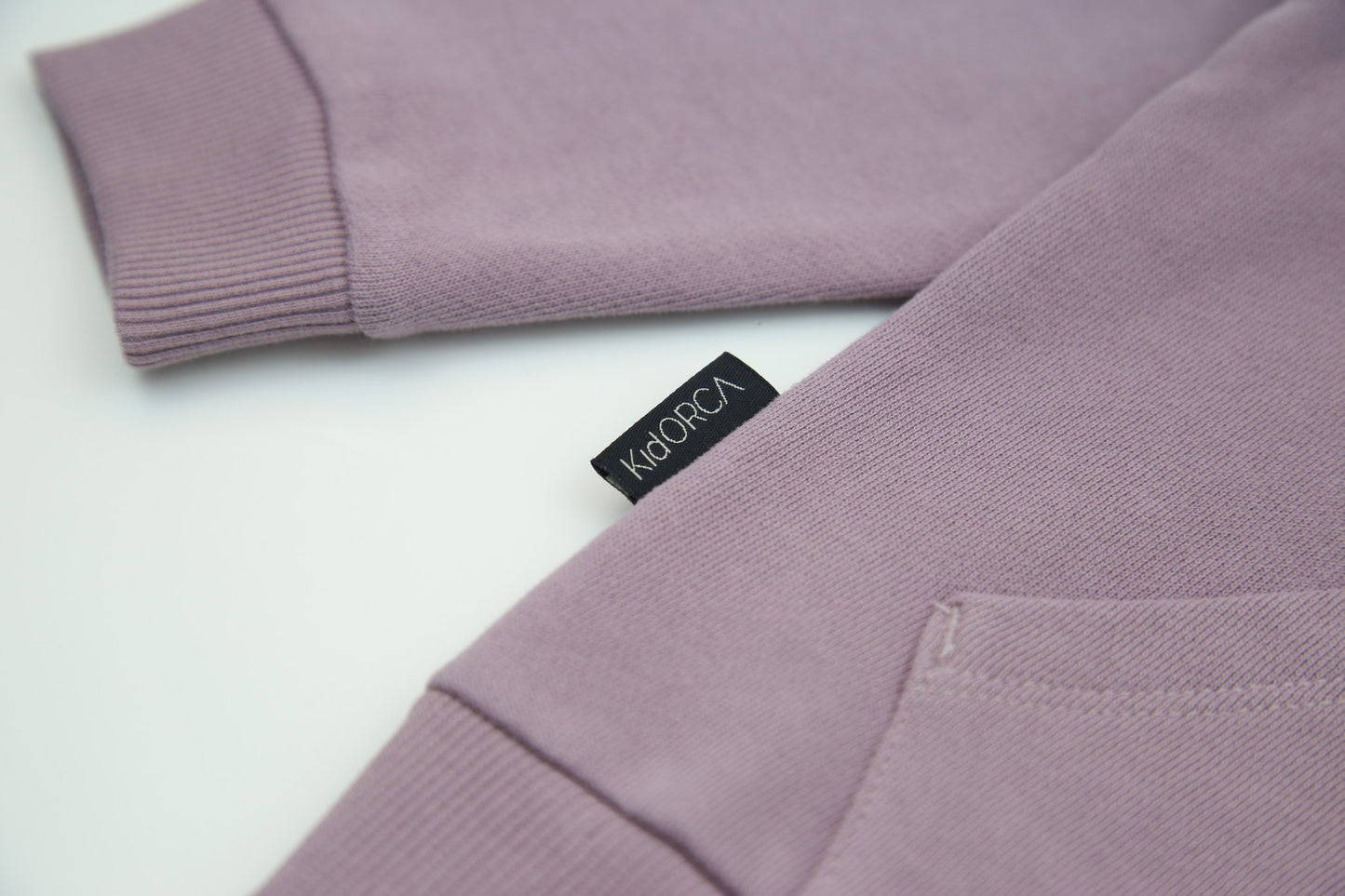 Rib cuff and hem detail on elderberry french terry kids sweatshirt