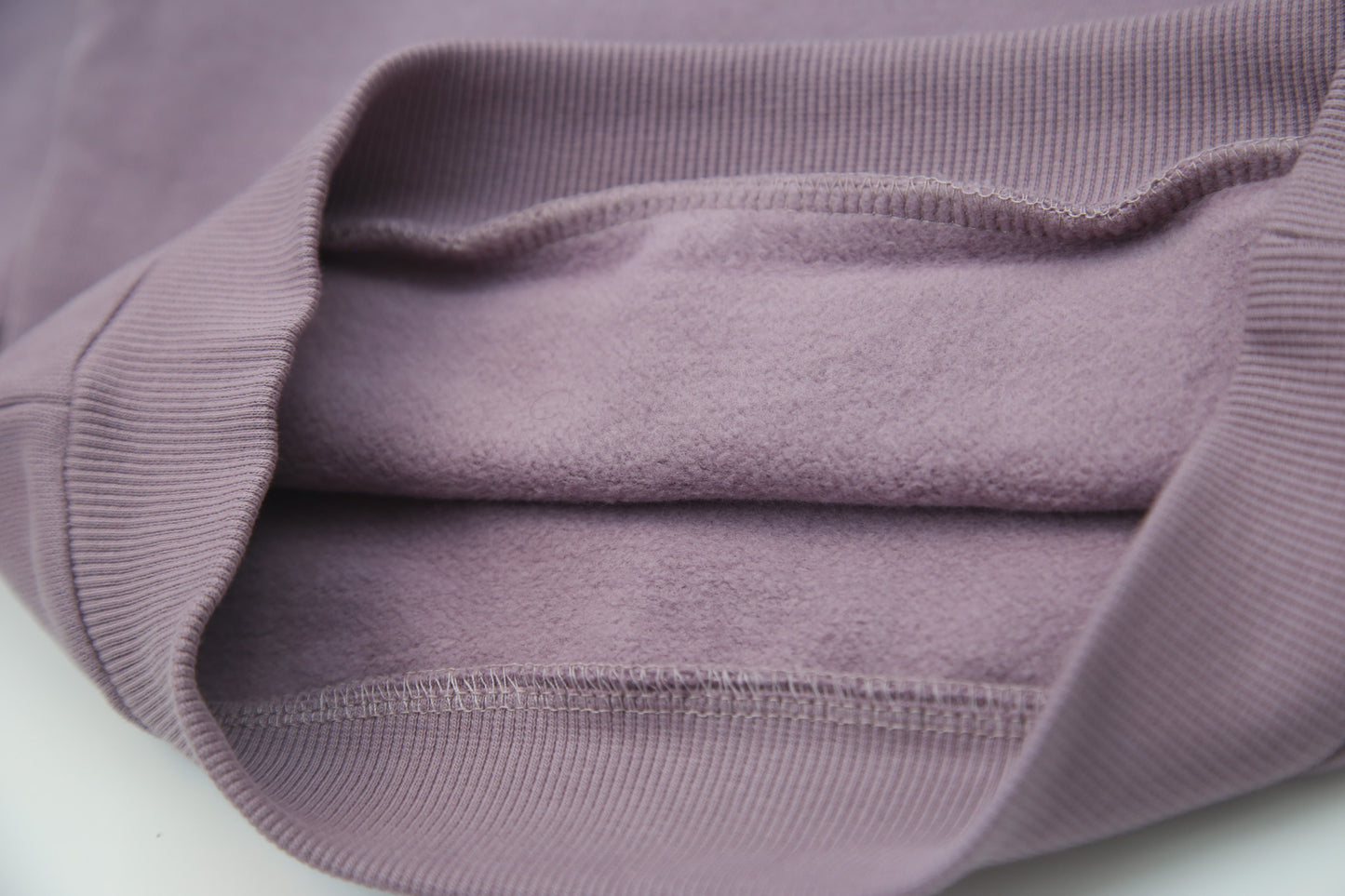 Rib cuff and hem detail on elderberry french terry kids sweatshirt