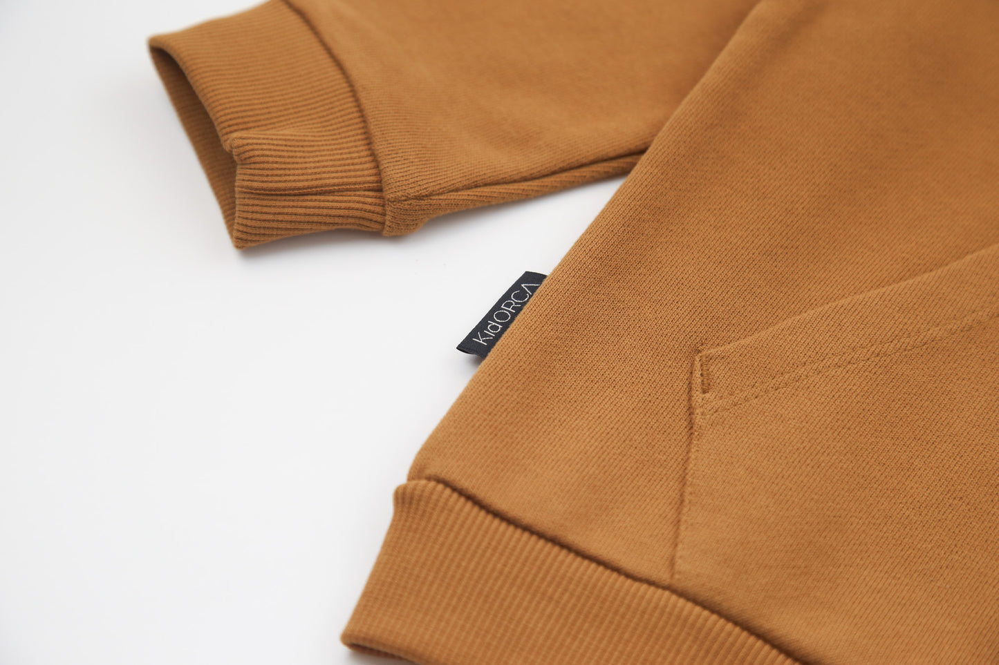 Kangaroo pocket and rib cuff detail on ginger french terry kids hoodie