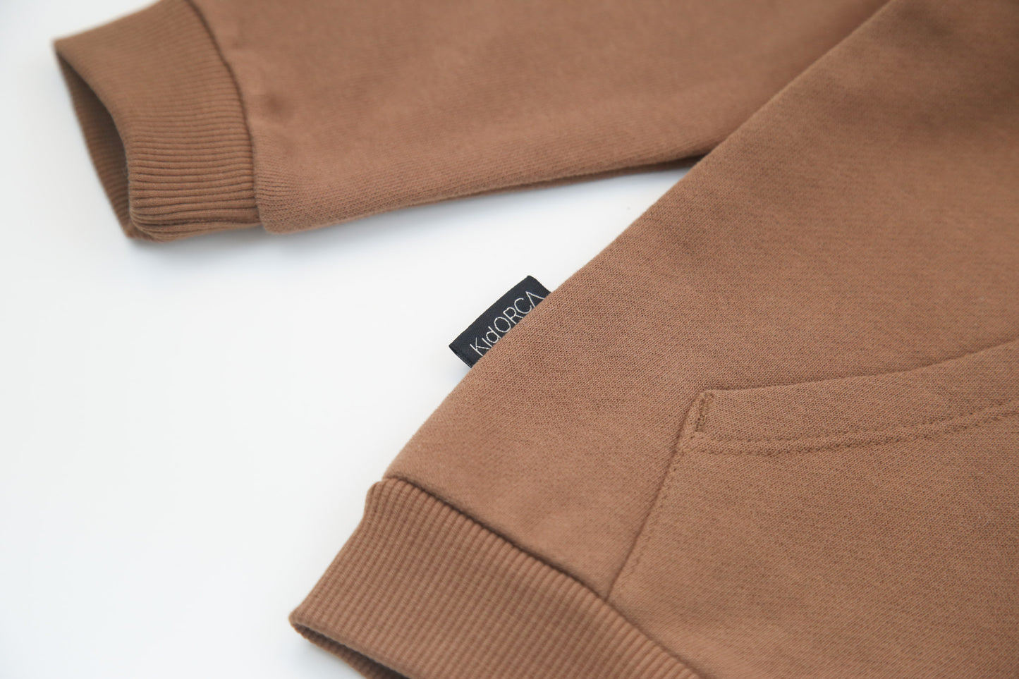 Kangaroo pocket and rib cuff detail on fjord french terry kids hoodie