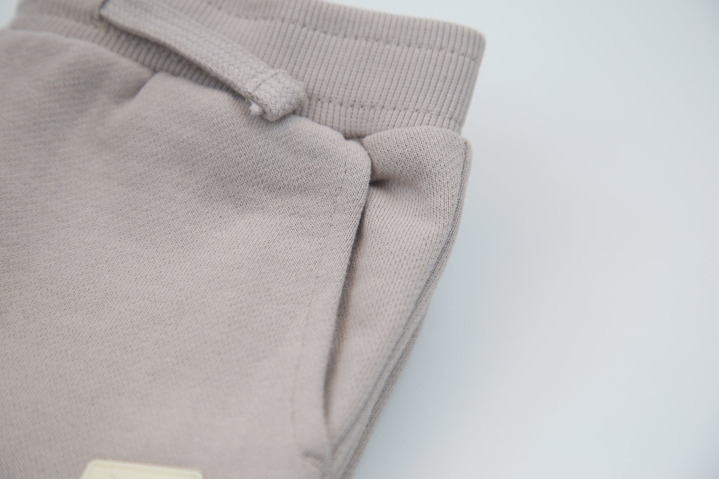 Rib cuff and side pocket detail on dove brushed terry kids sweatpants