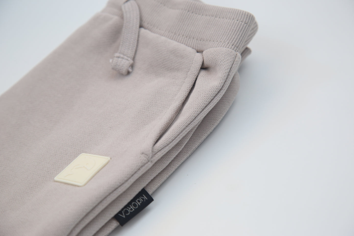 Rib cuff and side pocket detail on dove brushed terry kids sweatpants