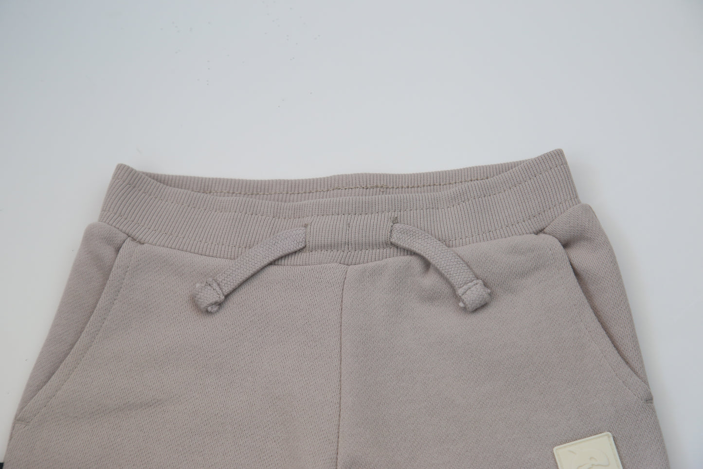 Rib cuff and side pocket detail on dove brushed terry kids sweatpants