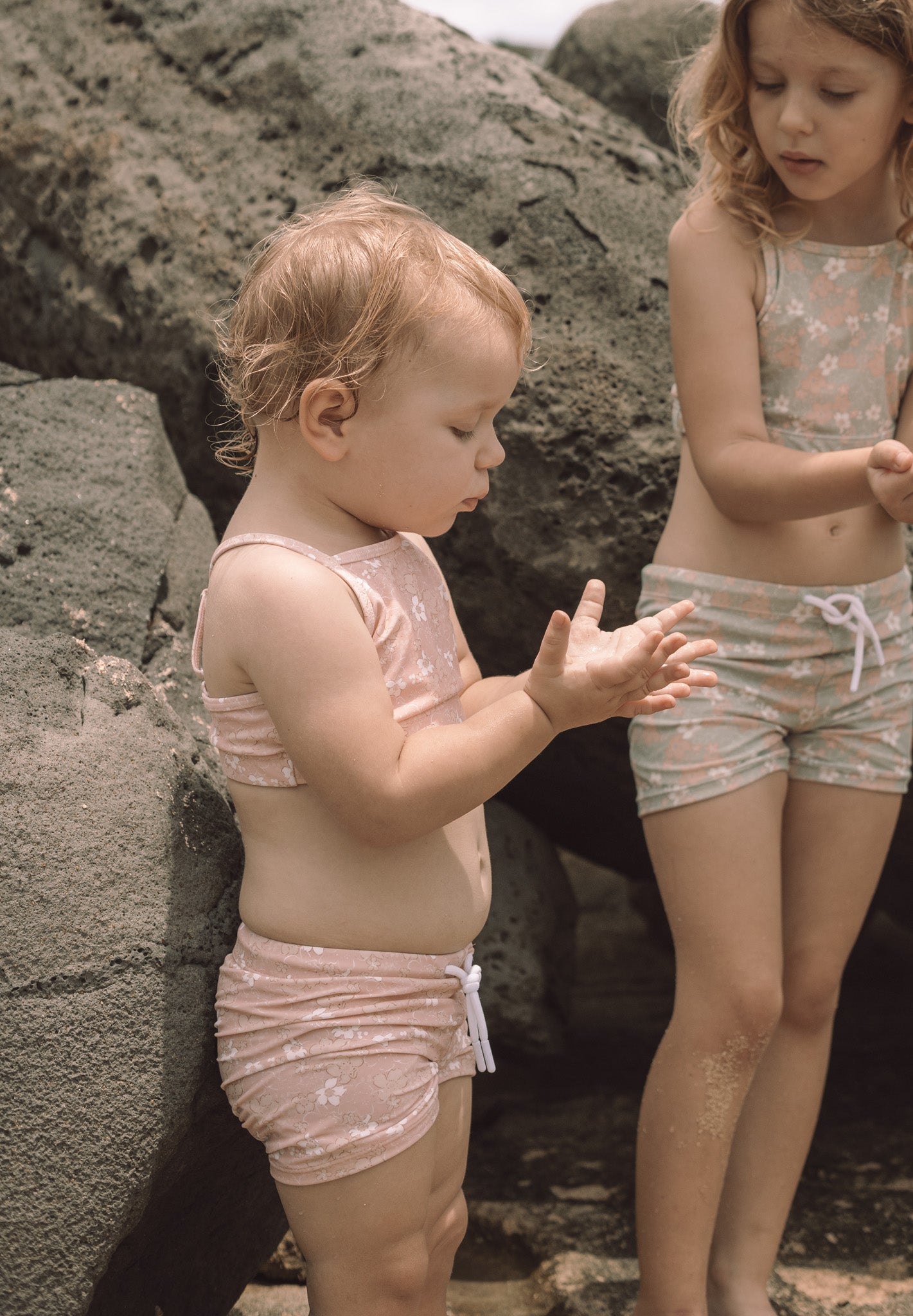 Girl playing in Tuscany print swim boardie shorts by KidORCA