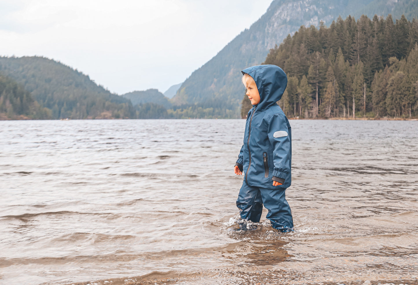 Child wearing navy waterproof rain pants by KidORCA