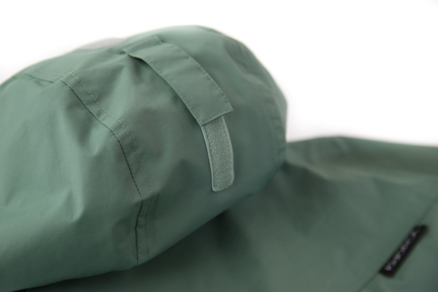Taped seams and adjustable hood detail – olive hard-shell rain jacket