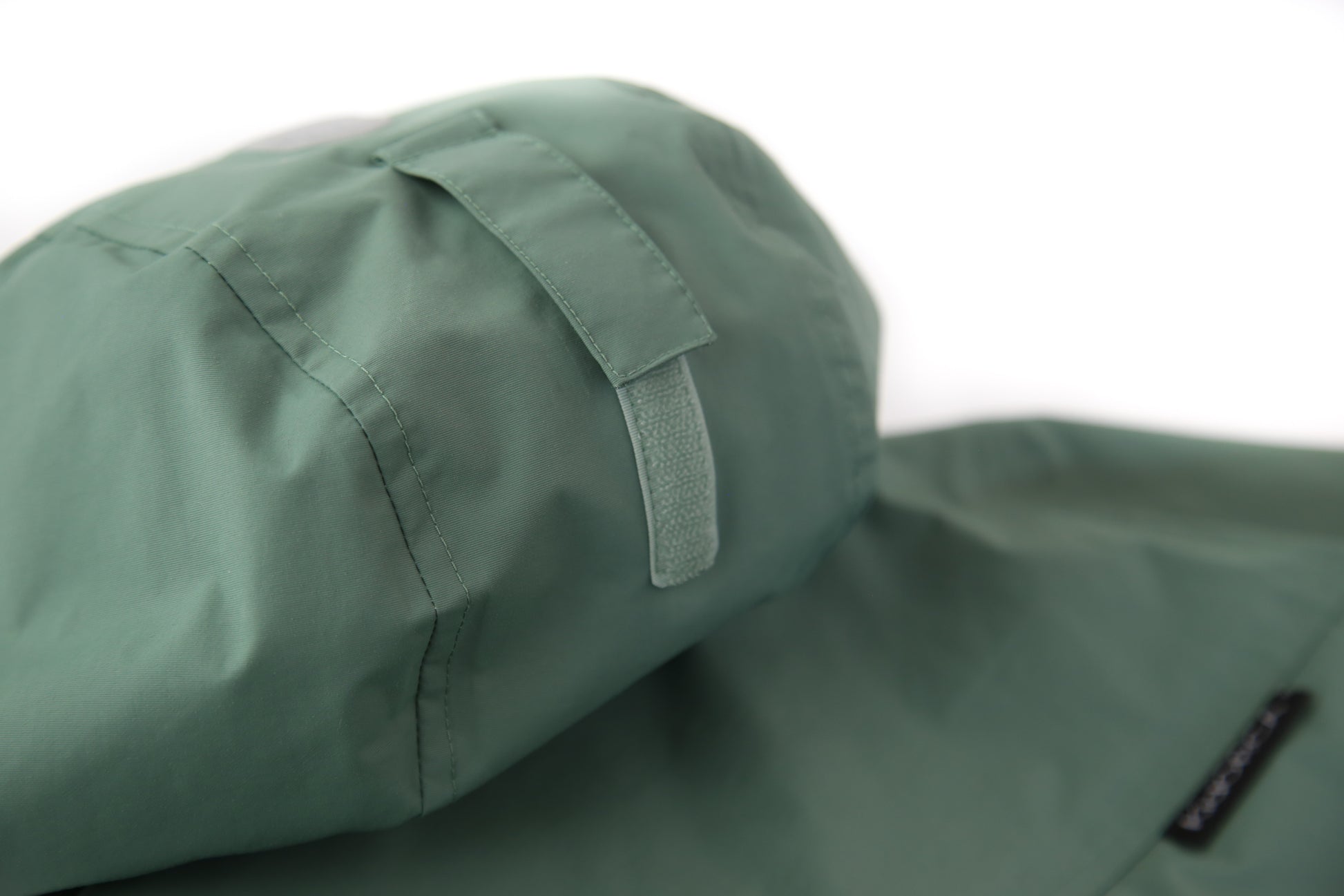 Taped seams and adjustable hood detail – olive hard-shell rain jacket