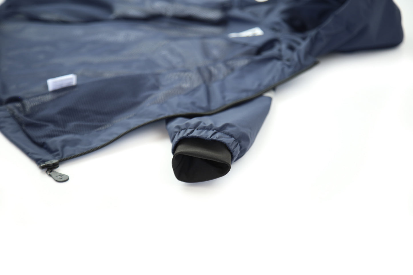 Close-up of waterproof zipper and high collar – navy rain jacket