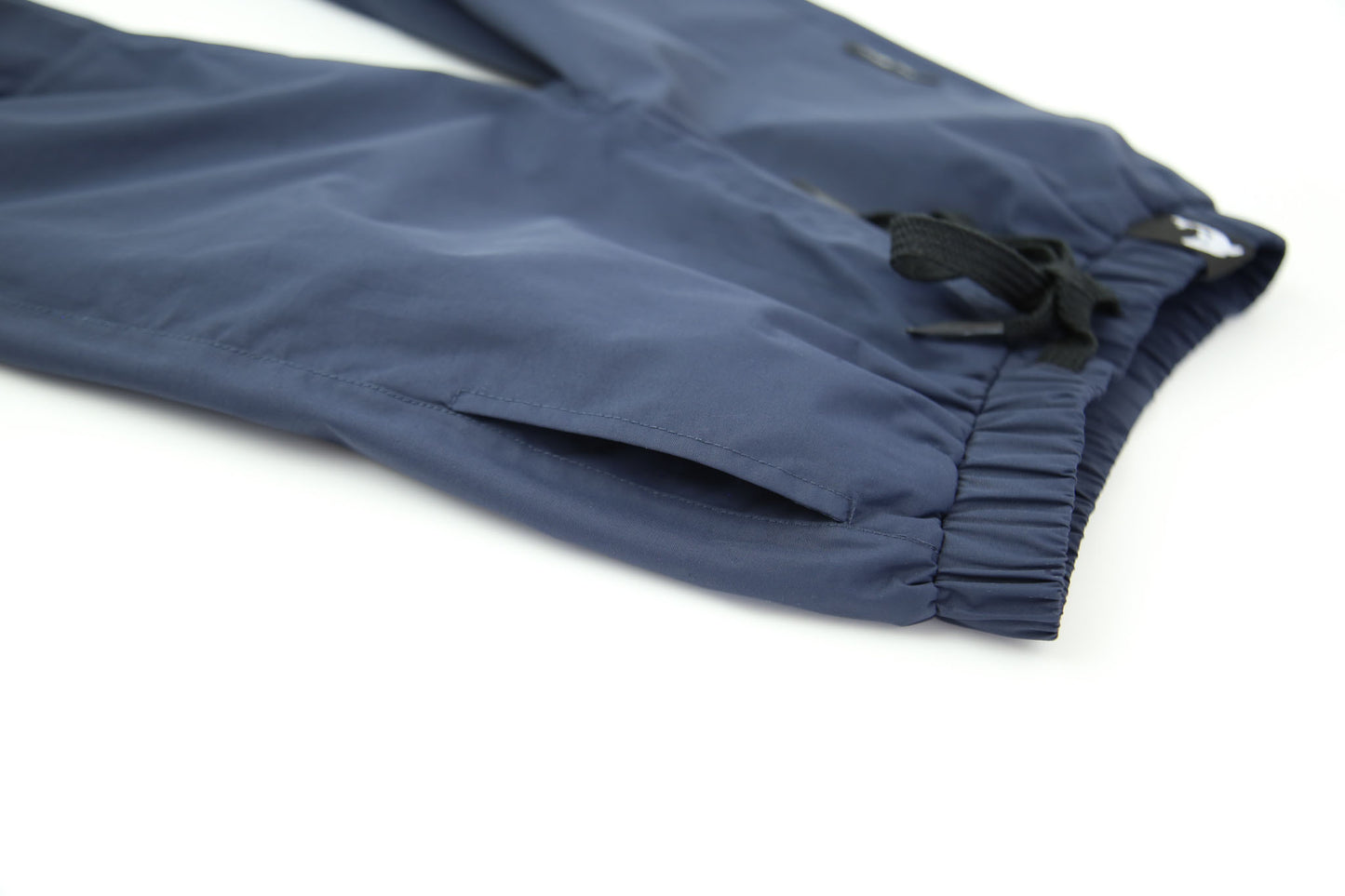 Elastic waistband detail – navy hard-shell rain pants