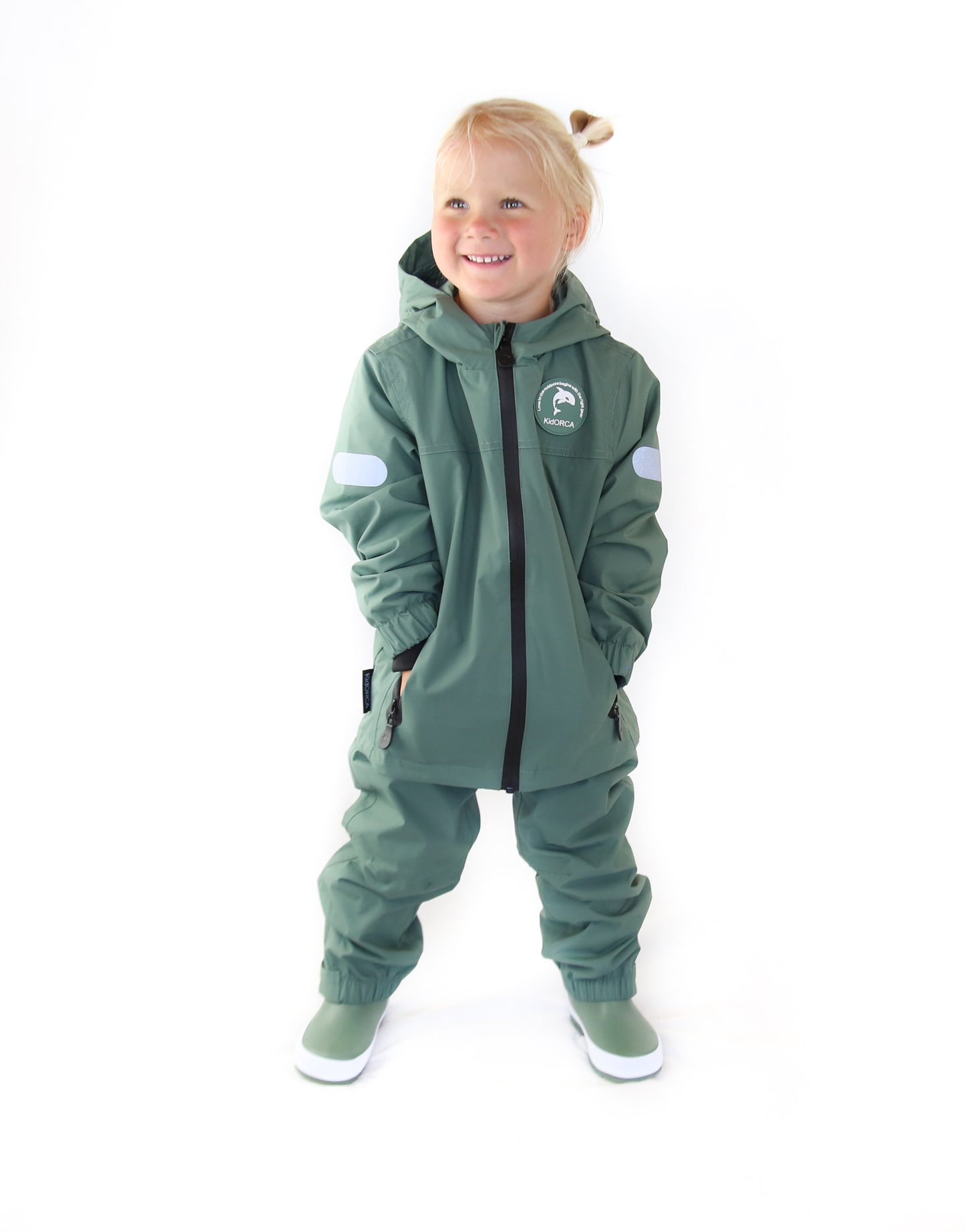 Child wearing olive hard-shell rain jacket – front view