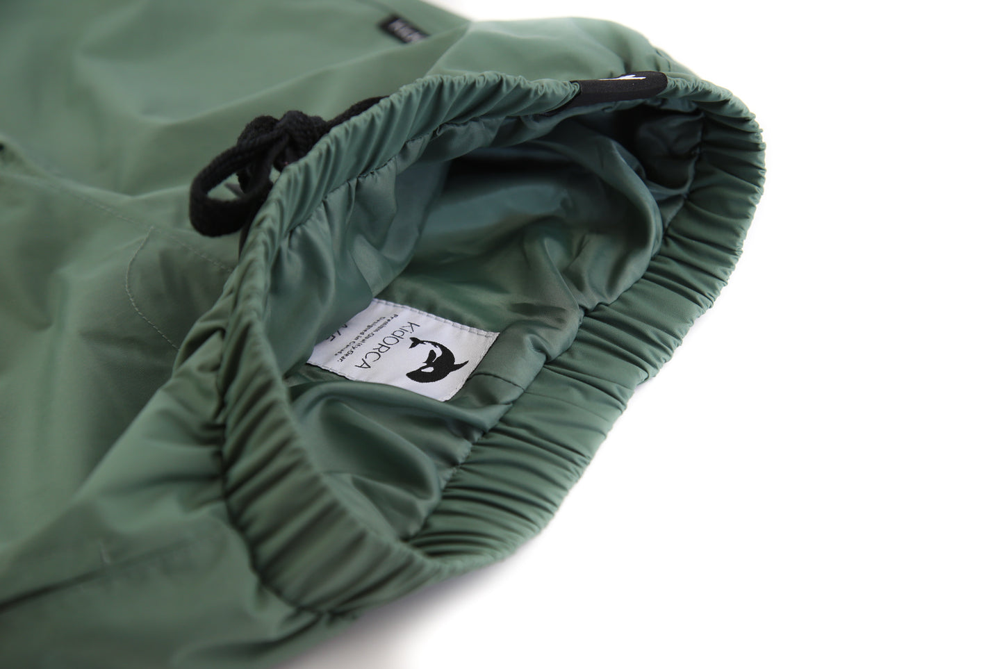 Elastic waistband detail – olive hard‑shell rain pants