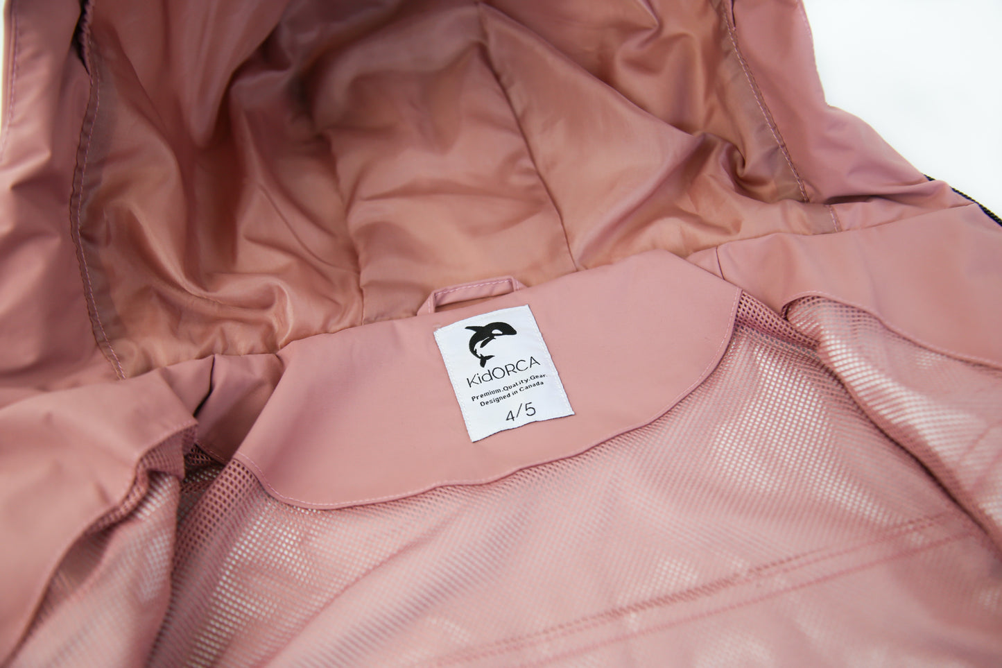 Taped seams and adjustable hood detail – ash‑rose hard-shell rain jacket