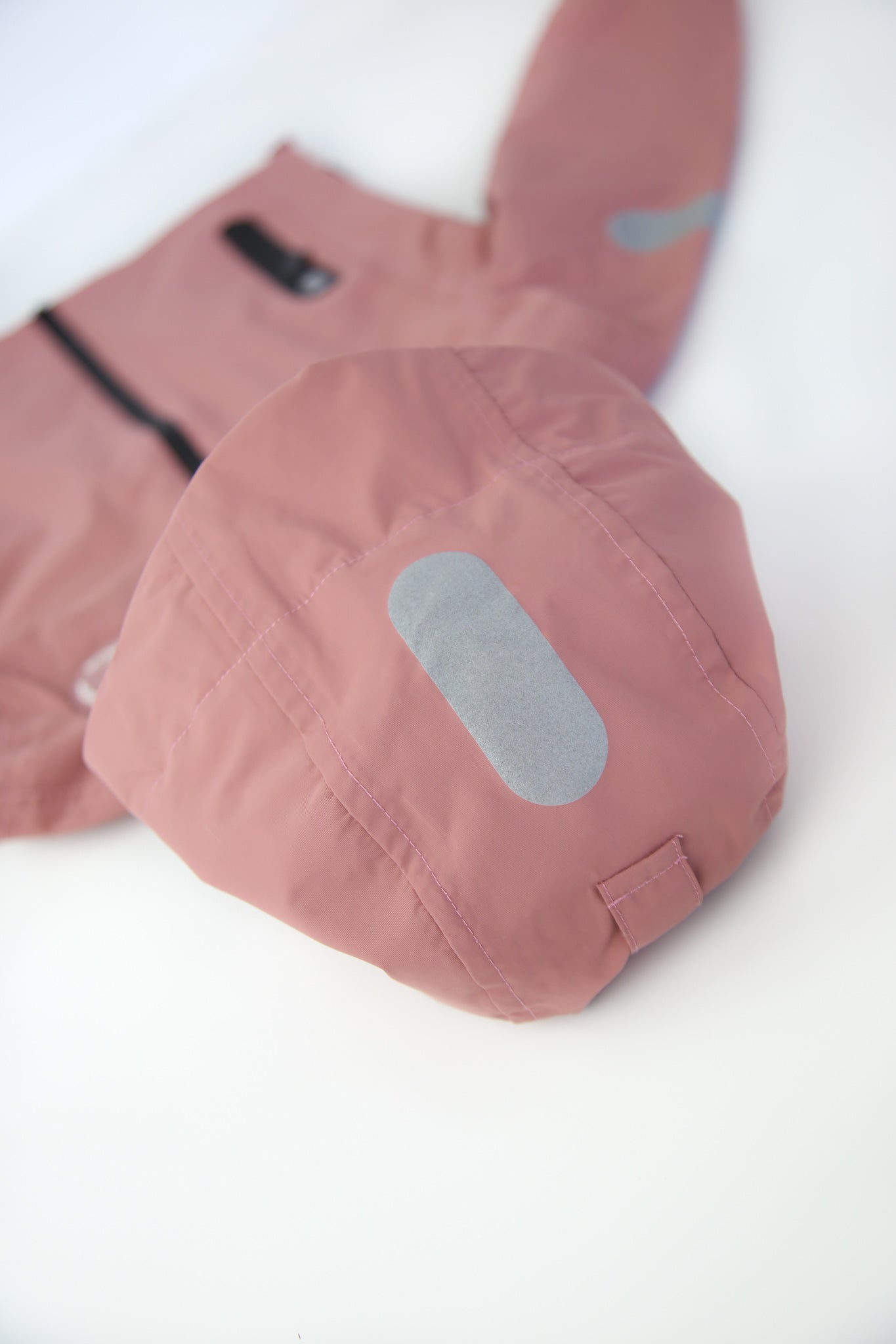 Taped seams and adjustable hood detail – ash‑rose hard-shell rain jacket