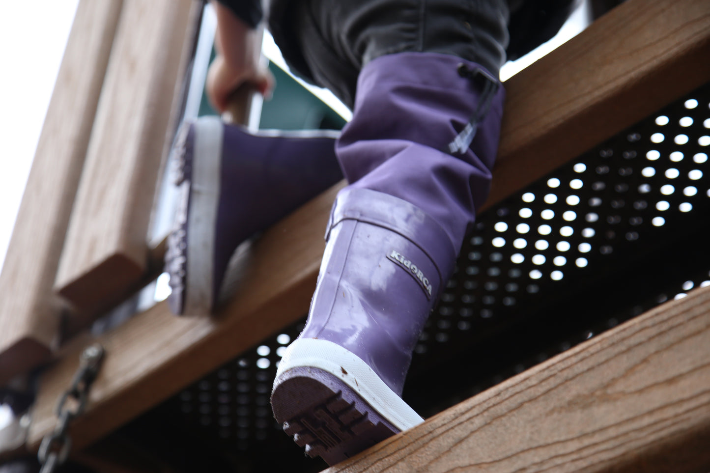 Child wearing grape above-knee rain waders – side view