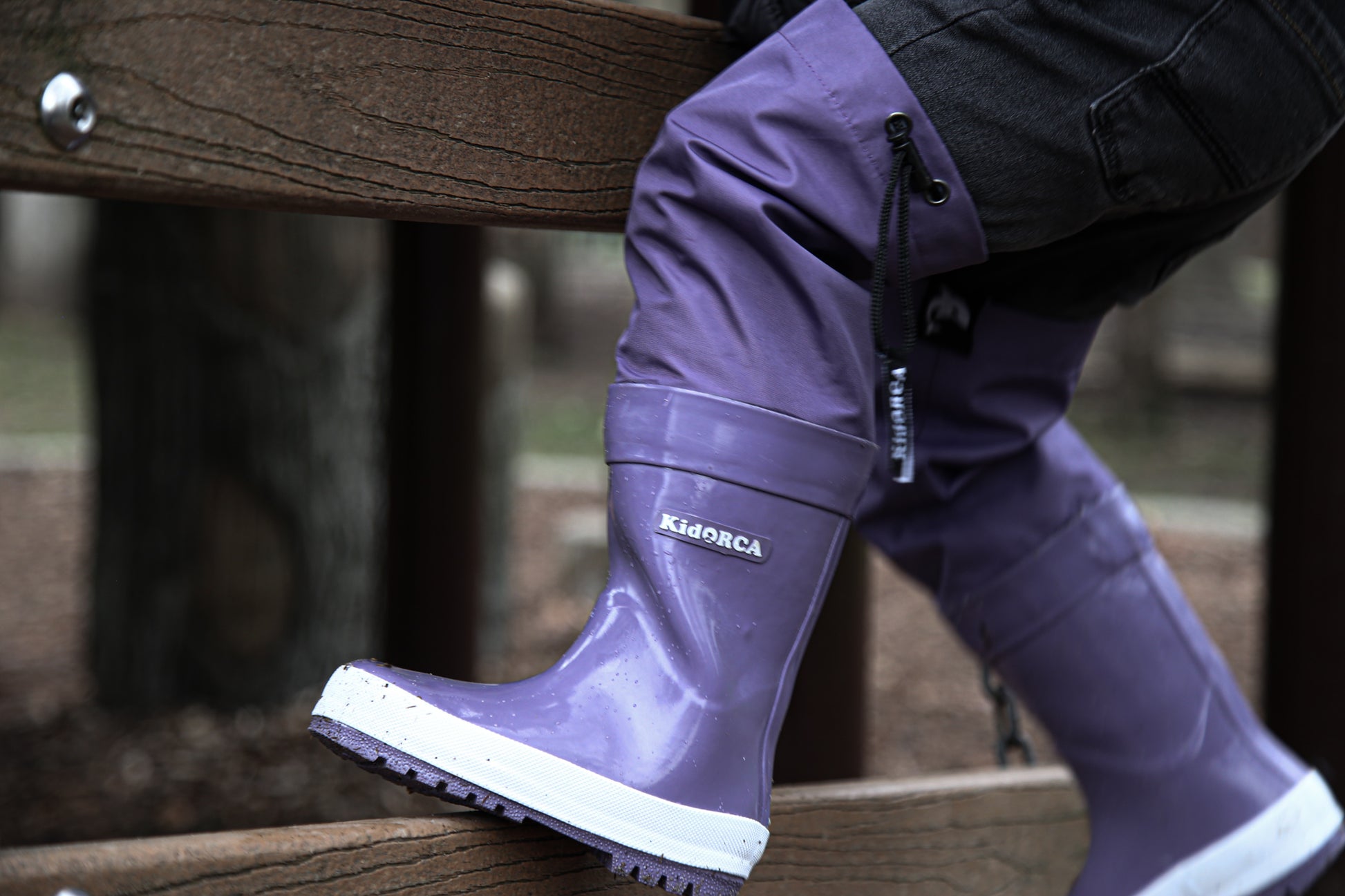Child wearing grape above-knee rain waders – side view